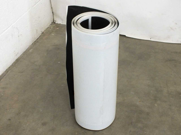 Xunlight XUS19-134 flexible solar panel rolled into cylinder standing upright, showing white ETFE top surface and dark amorphous cell underside