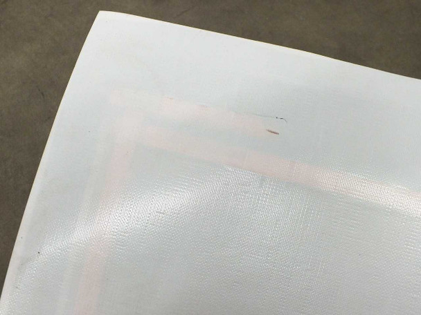 Close-up of Xunlight XUS19-134 ETFE top sheet corner showing cosmetic lamination blemish — delamination or bubble visible at edge