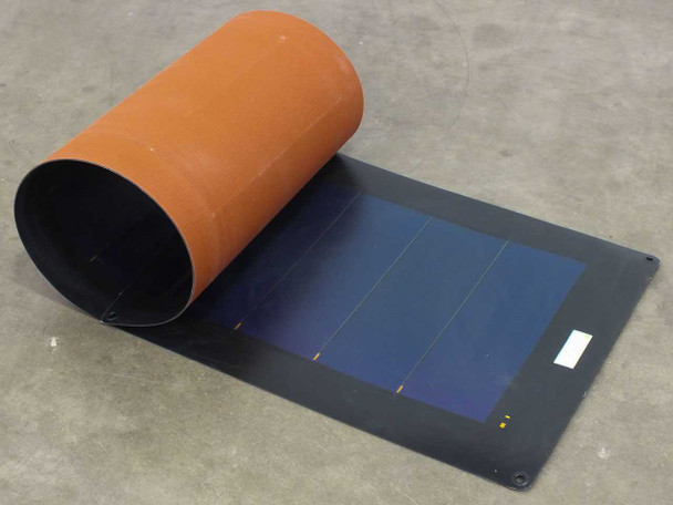 Xunlight XLS11-45 flexible amorphous solar panel partially unrolled from rolled cylinder position showing blue cell surface and orange backing