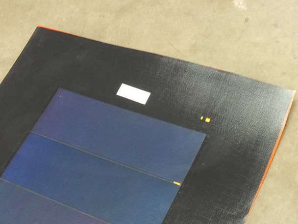 Close-up of iLand XSS11-45 solar panel top corner showing covered solder-point connections (yellow squares) and white label