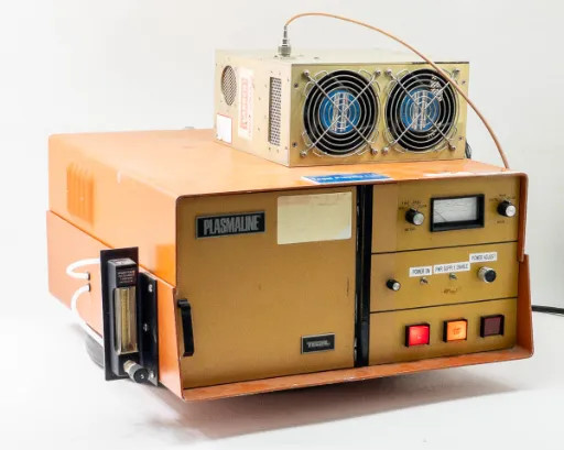 Tegal PlasmaLine 200 Plasma Barrel Etcher front-left view showing gas flow meter, PLASMALINE nameplate, and Comdel RF supply on top