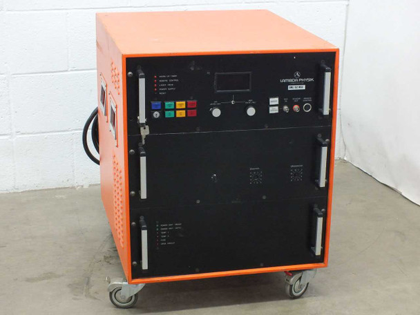 Lambda Physik EMG 102 MSC excimer laser power supply — front-left three-quarter view showing orange cabinet, front control panel, and caster base