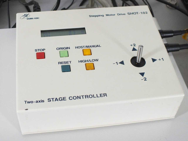 Sigma Koki SHOT-102 Stepping Motor Drive two-axis stage controller front panel showing STOP, ORIGIN, HOST/MANUAL, RESET, HIGH/LOW buttons and joystick