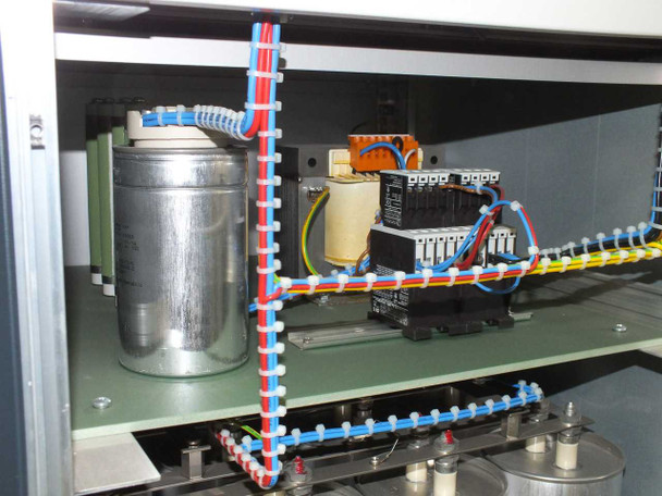 Upper interior compartment of Berger PSS10 showing toroidal transformer, relay/contactor bank, and wiring harness with blue/red/yellow cables