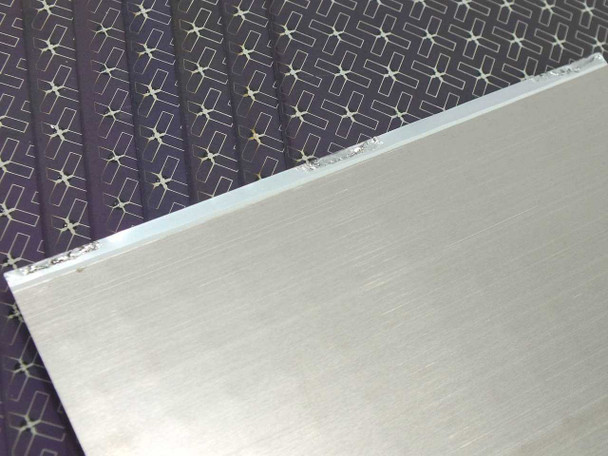 Close-up edge view of Nanosolar Nanocell CIGS solar cell showing thin aluminum base substrate and CIGS active layer thickness