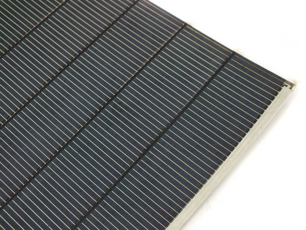 Close-up corner view of Solopower SP1 CIGS cell string showing individual tabbing wires and series-connected cell boundaries on stainless steel substrate