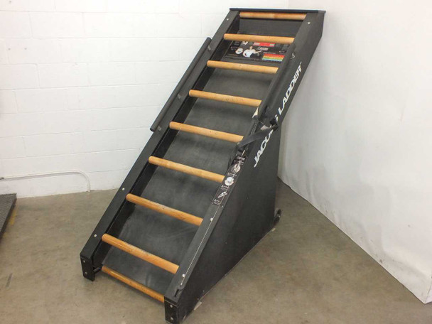 Jacobs Ladder commercial stair climber — three-quarter front view showing wood-rung continuous loop belt and dark steel frame at 40% incline