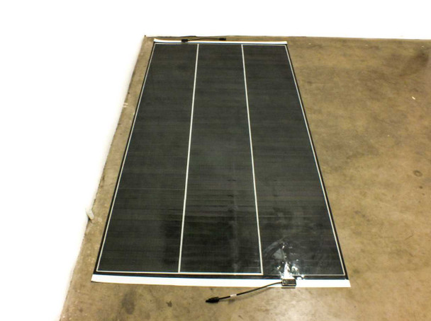 SoloPower SP3L-160 flexible CIGS solar panel laid flat on floor, direct top-down view showing three cell columns and thin aluminum edge frame