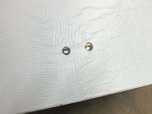Underside of Uni-Solar PVL-128 panel showing two bottom-facing copper solder point terminals
