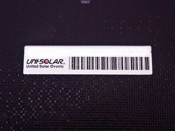 Uni-Solar United Solar Ovonic brand label and barcode on dark panel surface