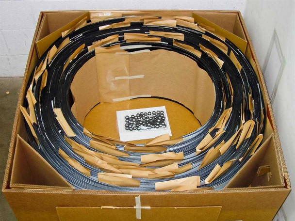 Interior view of Uni-Solar PVL-128 carton showing 30 panels coiled and packed with cardboard separators and hardware bag