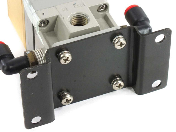 SMC ITV2050-31T2BL4 pressure regulator – underside of mounting bracket showing threaded port, four mounting screws, and two push-in pneumatic fittings