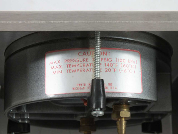 Close-up of Dwyer Instruments caution label on rear of gauge showing max pressure 15 PSIG (100 kPa), max temp 140°F (60°C), min temp 20°F (-6°C), made in Michigan City, USA