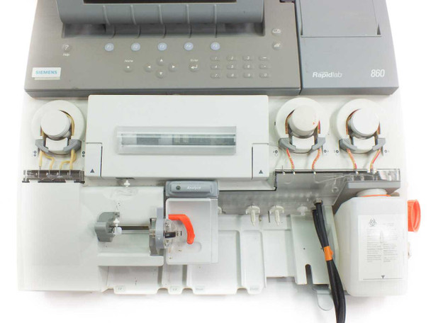 Siemens Rapidlab 860 internal reagent and sensor compartment with cover open showing tubing, reagent bottles, and fluid handling components