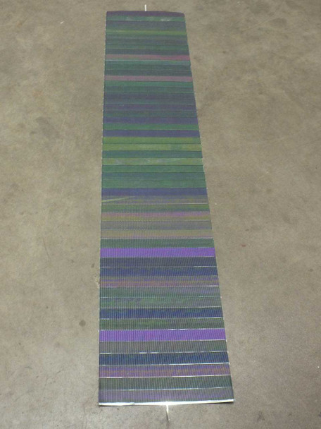 Solopower SP1 CIGS solar cell string laid flat on floor, showing full length of approximately 69 inches with alternating color cell bands