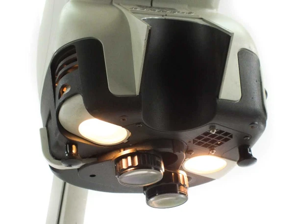 Vision Engineering Mantis microscope — bottom view of head showing dual halogen illuminators powered on and two objective lens ports