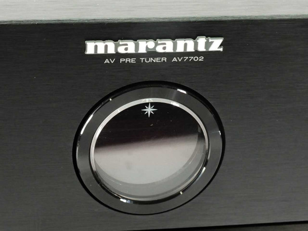 Close-up of Marantz AV7702 front panel center showing Marantz logo, AV PRE TUNER AV7702 designation, and volume knob with star indicator