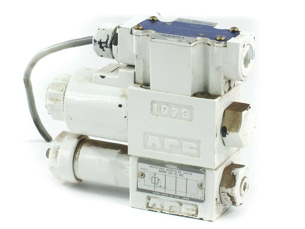Yuken DSG-01-2B2-D24-60 hydraulic directional valve with MRP-01-C-30 reducing modular valve — front-left three-quarter view showing IP73 enclosure rating and solenoid body