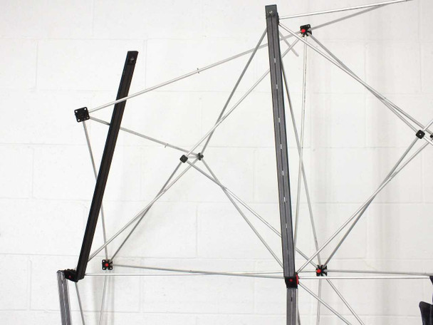 Close-up of Apex popup display frame upper section showing bent and damaged black vertical support arm