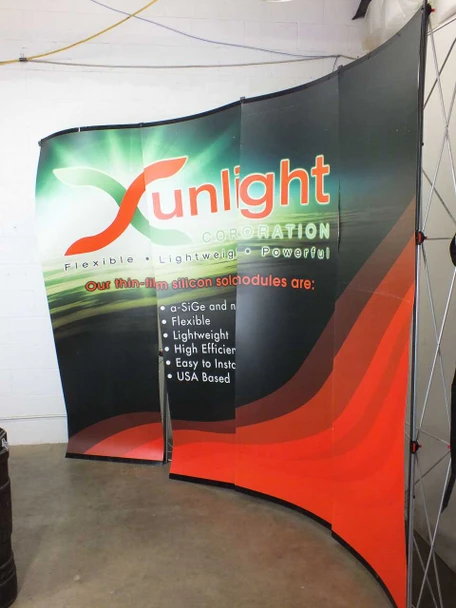 Apex 9904-QS 10-foot curved popup trade show display assembled with Sunlight Corporation graphic panels visible