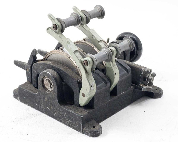 Moviola SYB synchronizer – rear three-quarter view showing both gang assemblies, film guide arms, sprocket teeth, and cast iron base with mounting flanges