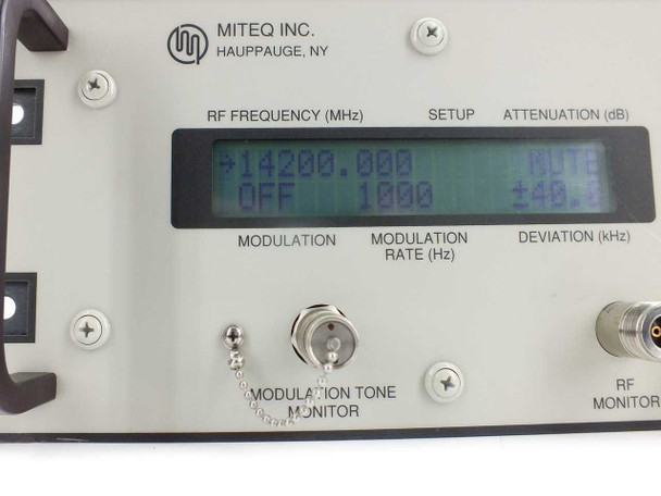 Miteq U-9456 Ku-Band Upconverter LCD display close-up showing RF frequency 14200.000 MHz, attenuation, modulation, modulation rate, and deviation readouts
