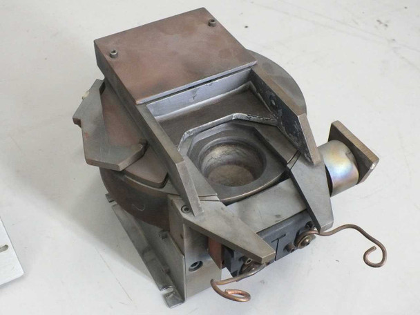 Multi-pocket evaporator assembly top view showing circular crucible pocket and copper body with spring contacts
