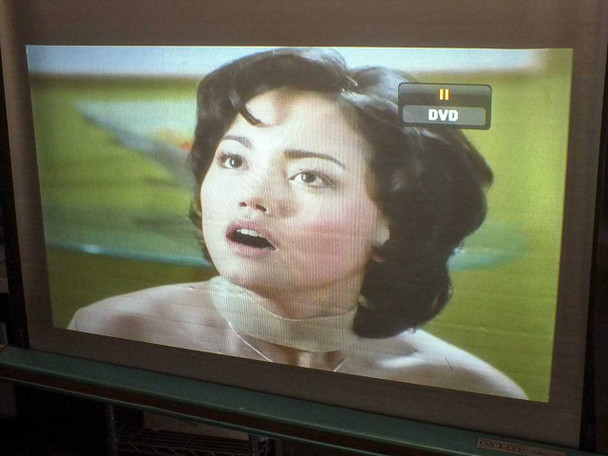 Runco LS-3 projector displaying DVD video — close-up projected image showing color and detail quality