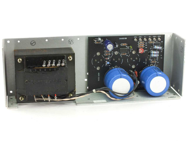 Power-One HE15-9-A interior view showing laminated-core transformer on left, control PCB center, and two large blue filter capacitors on right