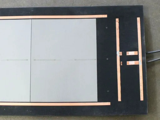 Uni-Solar PVL-136 panel corner section showing amorphous silicon cells, copper bus bars, and bypass diode interconnect strips