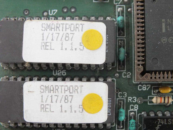 Close-up of two ROM chip labels on Arnet Smartport board reading 'SMARTPORT 1/17/87 REL 1.1.5'