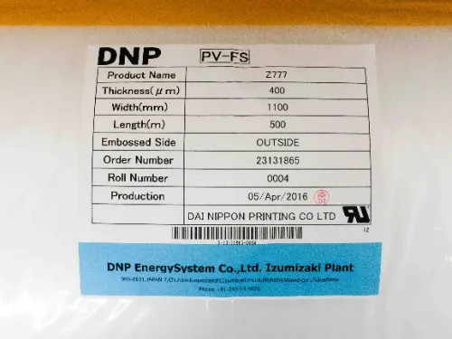 DNP PV-FS product specification label on roll showing Z777 model, 400µm thickness, 1100mm width, 500m length, embossed side outside, production date 05/Apr/2016, Dai Nippon Printing Co Ltd