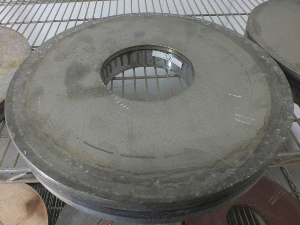 Top view of a thick gray abrasive Lapmaster lapping plate with center bore — heavy build-up of lapping compound residue
