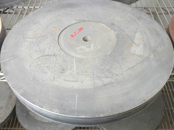 Top view of a large 16-inch flat gray lapping plate with red 'FLAT' label at center hub — scribe lines visible on surface