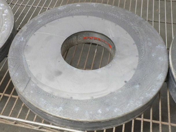 Top view of a Lapmaster lapping plate with a red label partially visible in the center bore area