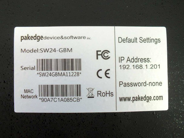 Pakedge SW24-GBM bottom label showing model number, serial number barcode, MAC address, FCC/CE/RoHS marks, and default IP address 192.168.1.201