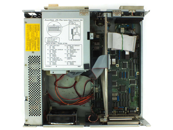 NEC PowerMate 286 Plus internal view — system board component side with PowerMate 286 Plus switch settings label, TDK power supply, and ribbon cables visible