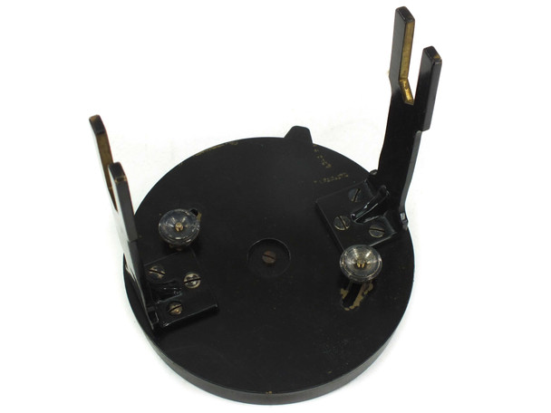 Underside of theodolite tribrach base plate showing three footscrew mounting points and locking mechanisms