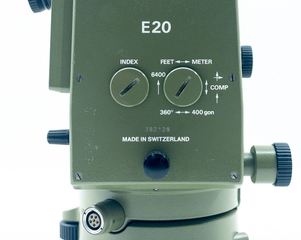 Kern E20 Theodolite front control panel close-up: INDEX dial, FEET/METER dial, 360°/400 gon/6400 mil markings, COMP indicator, serial number 382128, Made in Switzerland