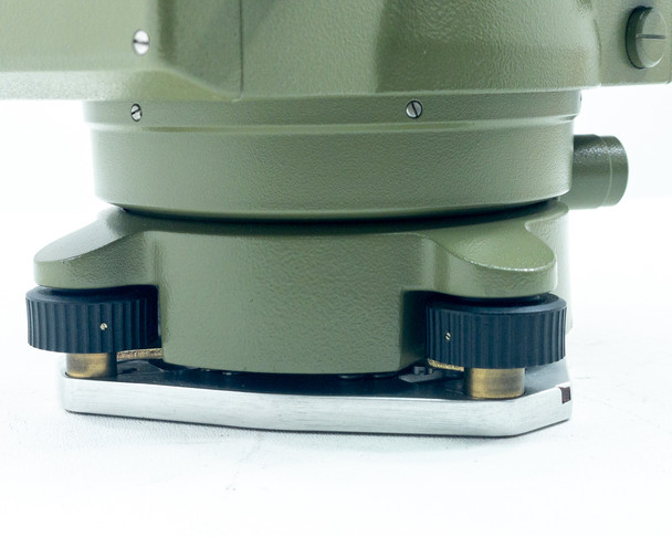 Kern E20 Theodolite lower base close-up showing three leveling footscrews with black knobs and brass contact points on aluminum base plate