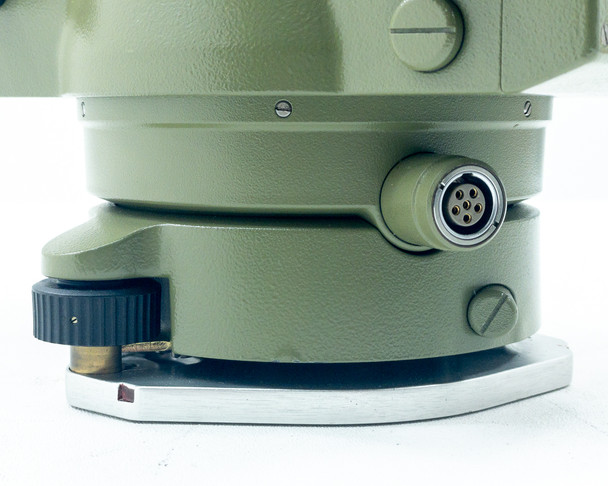 Kern E20 Theodolite lower base and 6-pin power connector close-up showing leveling tangent screw and tribrach plate