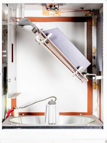 OAI 0130-041-04 – interior top-down view of open chamber showing angled mirror/filter on actuator arm, UV lamp on reflector bowl, and orange perimeter gasket