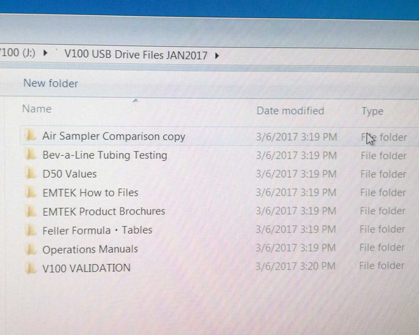 EMTEK V100 USB drive file contents showing V100 USB Drive Files JAN2017 folder with Operations Manuals, V100 Validation, EMTEK Product Brochures, and other support folders