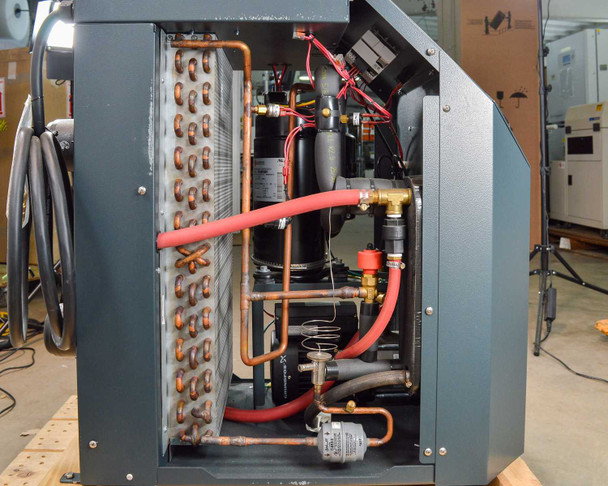 Haskris LX3-A2 – wide interior view with panel removed showing full refrigerant circuit: copper tube coils, compressors, red high-pressure lines, expansion valve, and Grundfos pump
