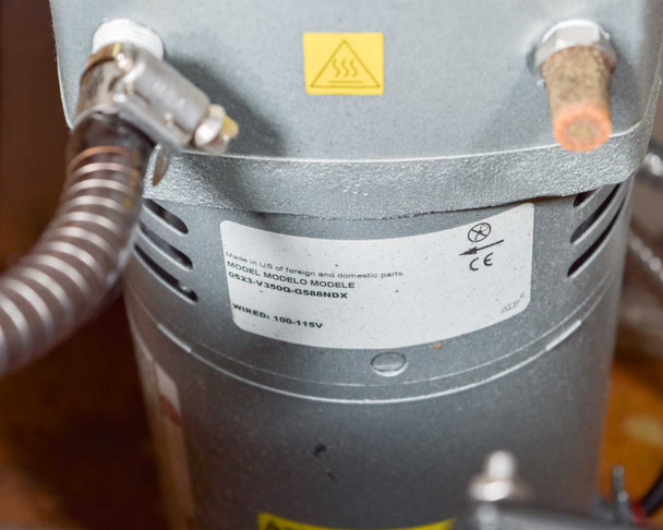Jun-Air 2000-25M – rear output port area showing two large brass hex fittings