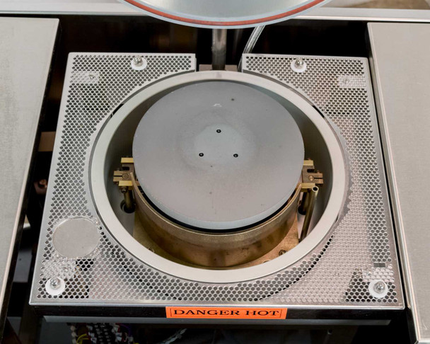 6-inch circular annealing hot plate with perforated surround plate, chuck detail showing three alignment pins, and copper-tone heating element ring visible below chuck