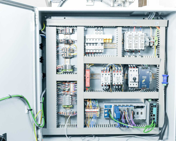 Hoffman CSD20168LG electrical enclosure interior showing DIN rail mounted circuit breakers, contactors, terminal blocks, and wiring harness — full panel view