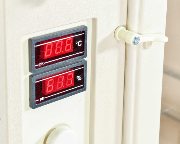 Grumbach incubator digital display detail showing temperature (°C) and humidity (%) red LED readouts with door latch hardware visible