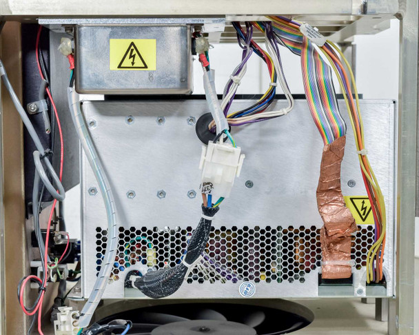 Lumenis LightSheer XC – interior lower section showing power supply unit with high-voltage warning labels and multi-color wiring