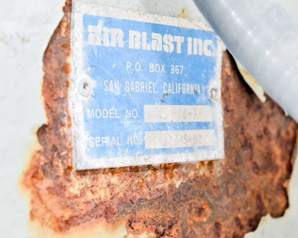 Air Blast Inc nameplate label showing model number 27-18-3 and serial number, San Gabriel California, with heavy surface rust on housing